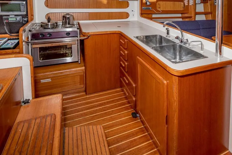 Harriet Tubman Yacht Photos Pics Wooden yacht kitchen interior with stove, double sink, and storage, Caliber 40, 2002 model.