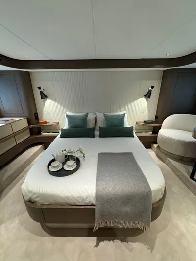  Yacht Photos Pics Luxurious bedroom interior of 2025 Azimut Magellano 66 yacht with modern decor and cozy bedding.