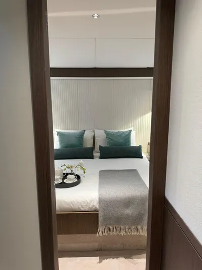  Yacht Photos Pics Luxurious bedroom interior of 2025 Azimut Magellano 66 yacht with elegant decor.
