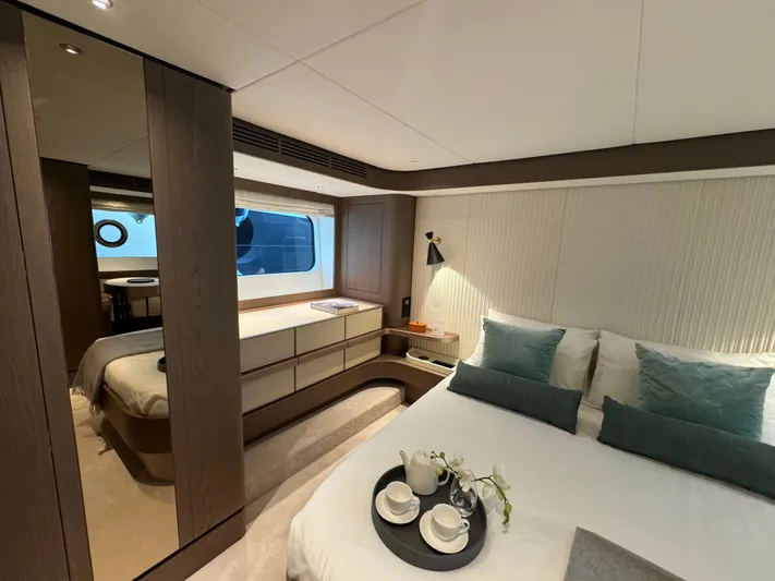  Yacht Photos Pics Luxurious bedroom interior of 2025 Azimut Magellano 66 yacht with modern design and elegant decor.