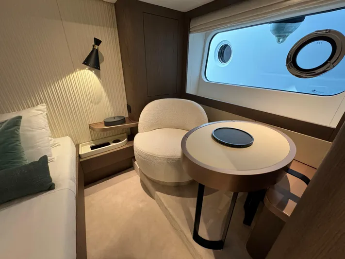 Yacht Photos Pics Luxurious interior of 2025 Azimut Magellano 66 yacht with elegant seating and window view.