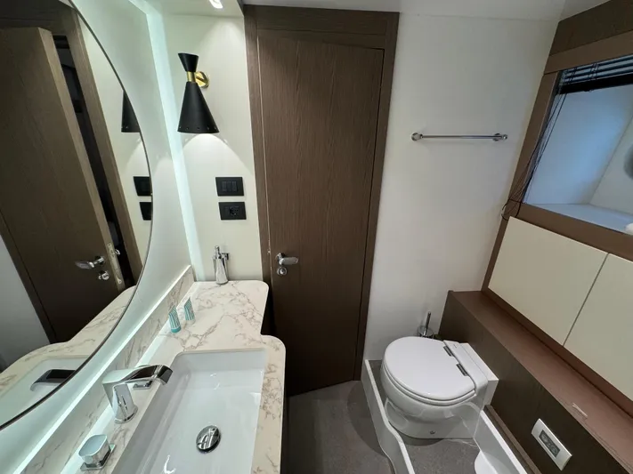  Yacht Photos Pics Luxurious bathroom in 2025 Azimut Magellano 66 yacht with modern fixtures and elegant design.