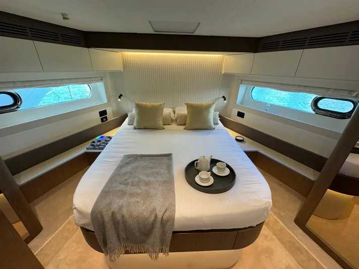  Yacht Photos Pics Luxurious bedroom interior of 2025 Azimut Magellano 66 yacht with elegant decor and ocean view.