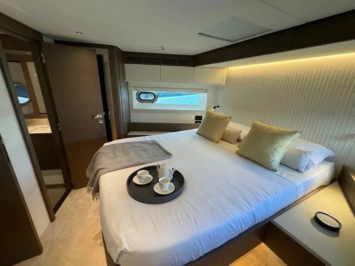  Yacht Photos Pics Luxurious bedroom interior of 2025 Azimut Magellano 66 yacht with elegant decor.
