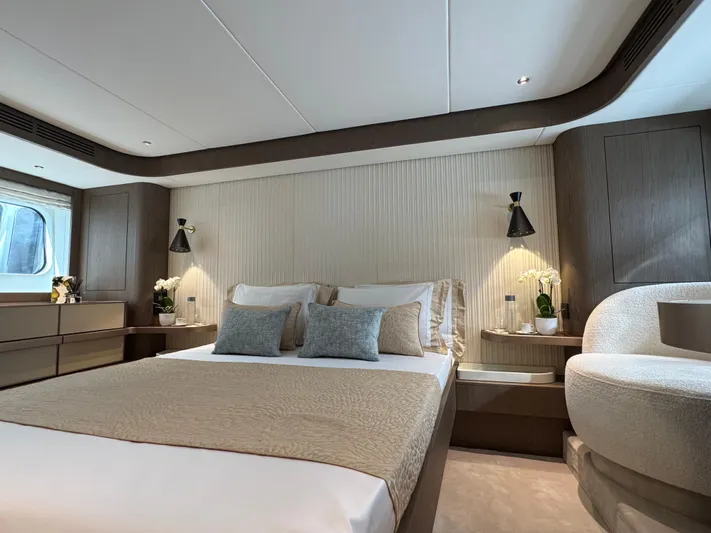  Yacht Photos Pics Luxurious bedroom interior of 2025 Azimut Magellano 66 yacht, featuring modern design and elegant furnishings.