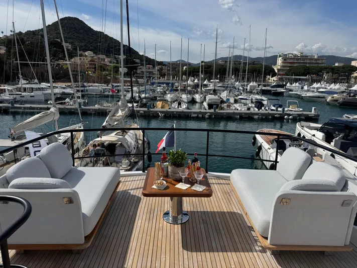  Yacht Photos Pics Luxurious 2025 Azimut Magellano 66 yacht deck with elegant seating and marina view.