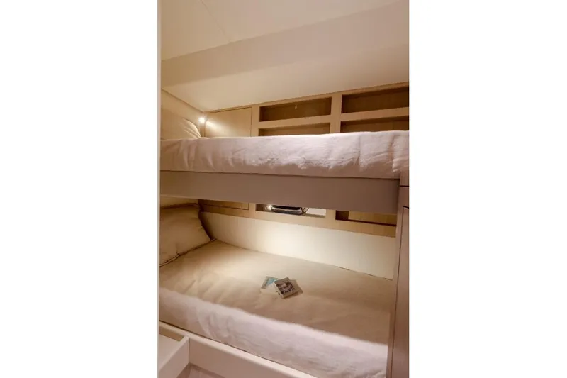  Yacht Photos Pics Bunk beds in 2025 Azimut Magellano 66 yacht cabin, featuring modern design and cozy lighting.