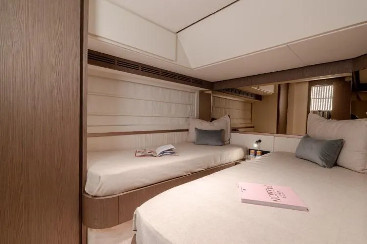  Yacht Photos Pics Luxurious cabin interior of 2025 Azimut Magellano 66 yacht with cozy twin beds.