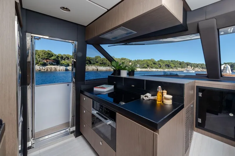  Yacht Photos Pics Modern kitchen interior on 2025 Azimut Magellano 66 yacht with ocean view.