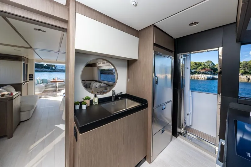  Yacht Photos Pics Luxurious interior of 2025 Azimut Magellano 66 yacht with modern kitchen and ocean view.