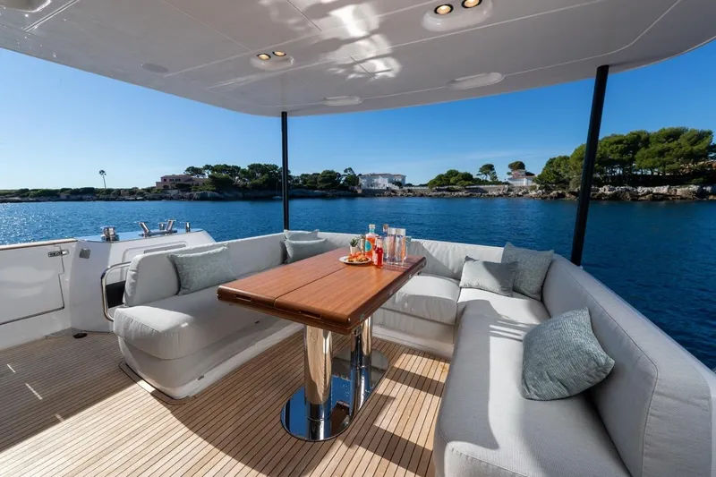  Yacht Photos Pics Luxurious 2025 Azimut Magellano 66 yacht deck with elegant seating and ocean view.
