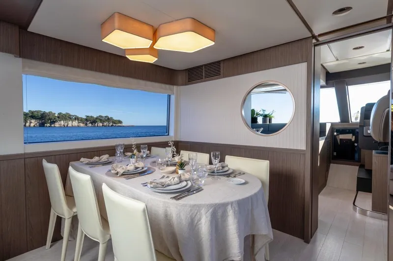  Yacht Photos Pics Luxurious dining area on 2025 Azimut Magellano 66 yacht with ocean view.