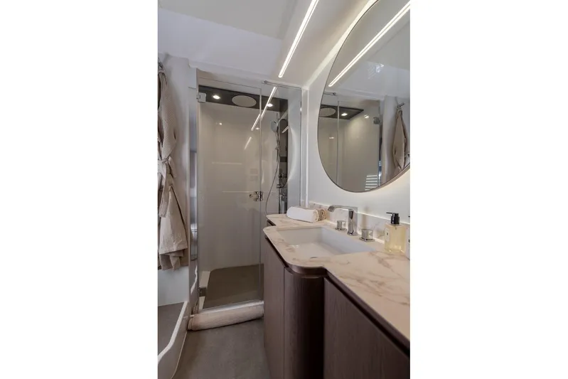  Yacht Photos Pics Luxurious bathroom in 2025 Azimut Magellano 66 yacht with modern fixtures and elegant design.