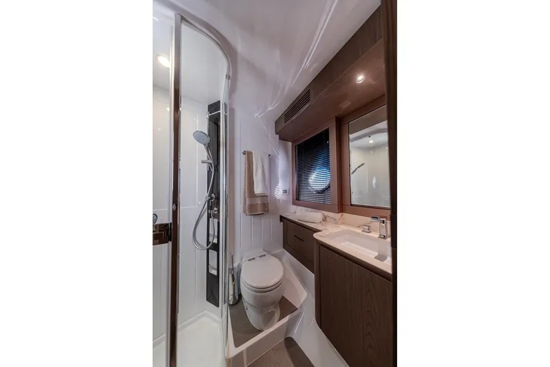  Yacht Photos Pics Luxurious bathroom in 2025 Azimut Magellano 66 yacht with modern fixtures and elegant design.