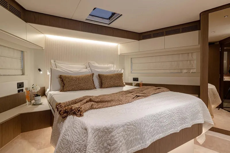  Yacht Photos Pics Luxurious bedroom interior of 2025 Azimut Magellano 66 yacht, featuring elegant bedding and modern design.