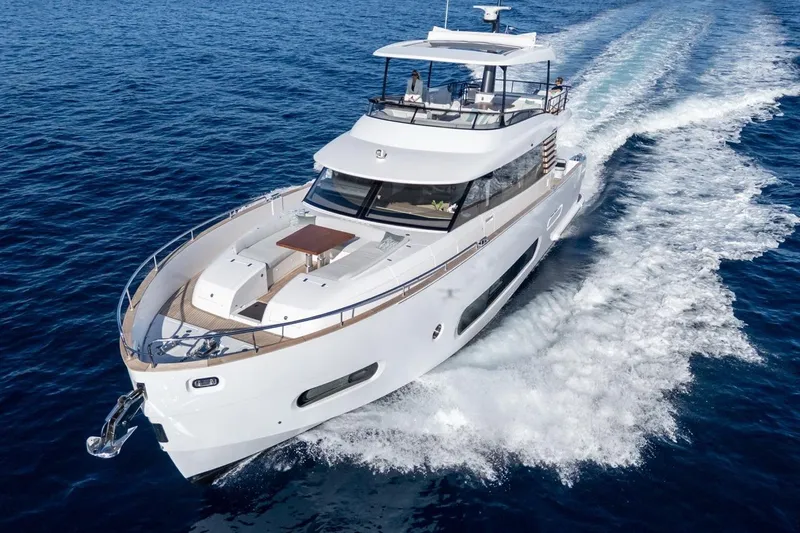  Yacht Photos Pics 2025 Azimut Magellano 66 yacht cruising on open sea, showcasing sleek design and luxury.