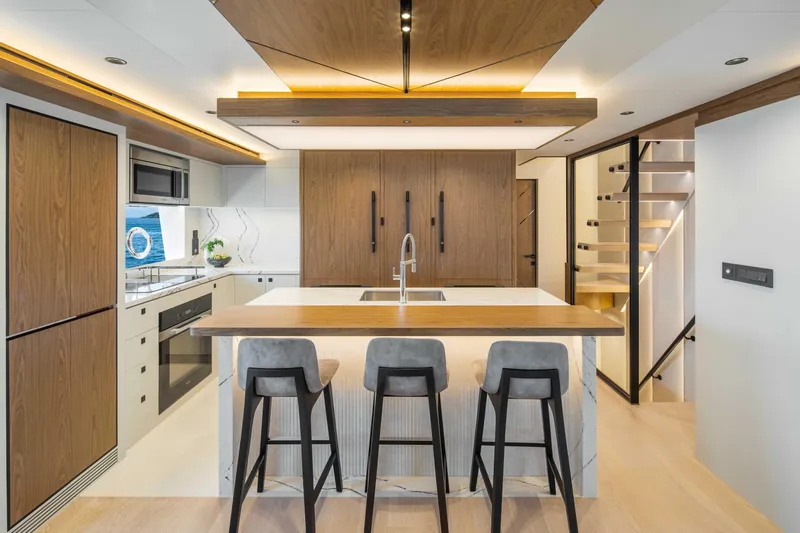 Horizon Fd80-617 / Now Available Yacht Photos Pics Modern kitchen interior on Horizon FD80 yacht, 2026 model, featuring sleek design and wooden accents.