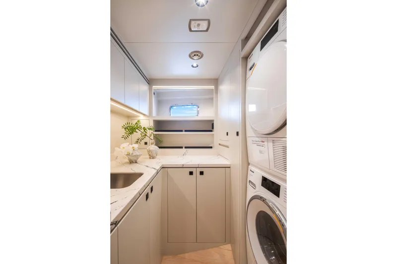 Horizon Fd80-617 / Now Available Yacht Photos Pics Modern laundry room in 2026 Horizon FD80 yacht with washer, dryer, and sleek cabinetry.