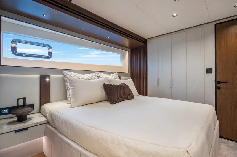 Horizon Fd80-617 / Now Available Yacht Photos Pics Luxurious bedroom interior of 2026 Horizon FD80 yacht with modern design and large window.