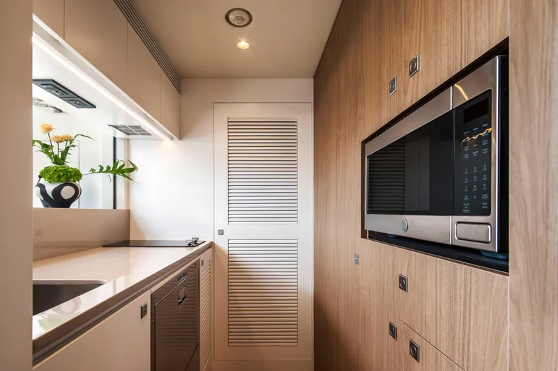 Horizon Fd80-617 / Now Available Yacht Photos Pics Modern kitchen interior on Horizon FD80 yacht, featuring sleek appliances and wood paneling, 2026 model.