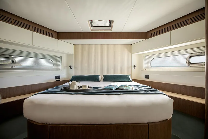  Yacht Photos Pics Luxurious bedroom interior of 2025 Azimut Magellano 66 yacht with elegant design and natural light.