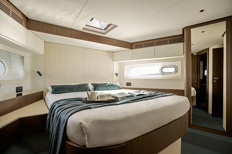  Yacht Photos Pics Luxurious bedroom interior of 2025 Azimut Magellano 66 yacht, featuring elegant design and cozy ambiance.