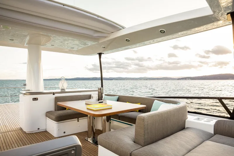  Yacht Photos Pics Luxurious 2025 Azimut Magellano 66 yacht deck with elegant seating and ocean view.