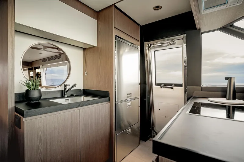  Yacht Photos Pics Modern kitchen interior of 2025 Azimut Magellano 66 yacht with sleek design and ocean view.