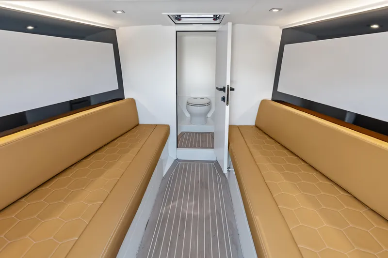R01 Yacht Photos Pics Interior of 2023 VanDutch 32 yacht with tan seating and modern bathroom.