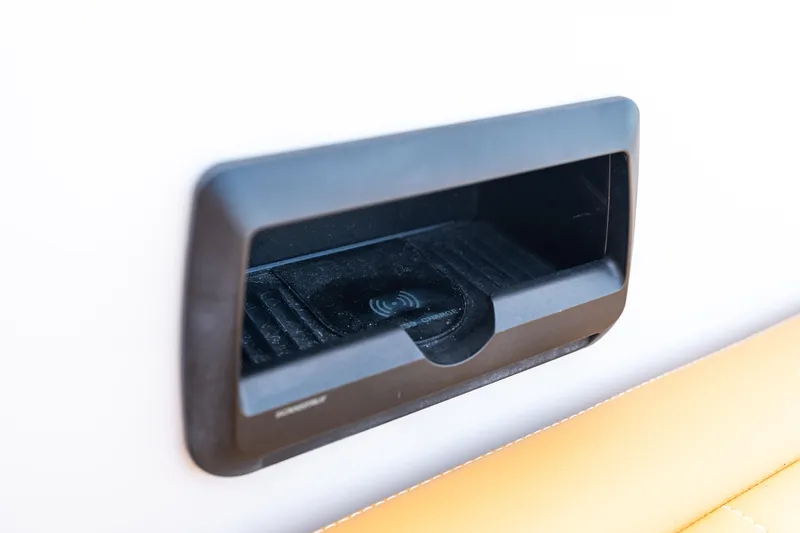 R01 Yacht Photos Pics VanDutch 32 (2023) wireless charging dock on a sleek boat interior.