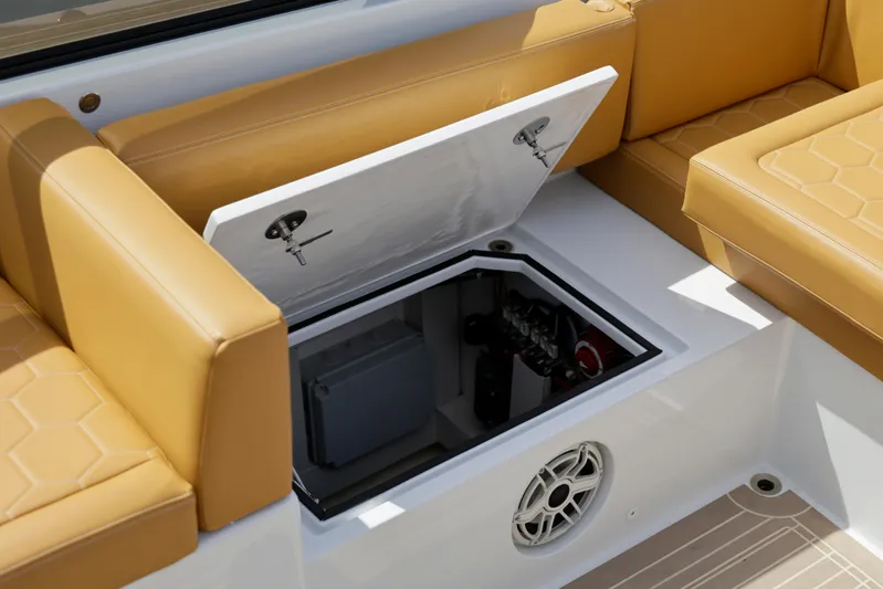 R01 Yacht Photos Pics 2023 VanDutch 32 boat interior with open storage compartment and tan seating.