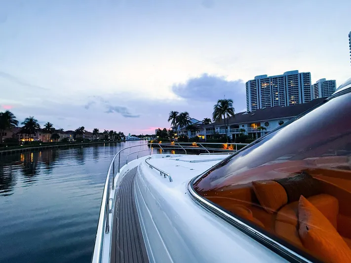 Kristina Yacht Photos Pics Luxury yacht cruising through a scenic canal at sunset, featuring a 2007 Princess 23M model.
