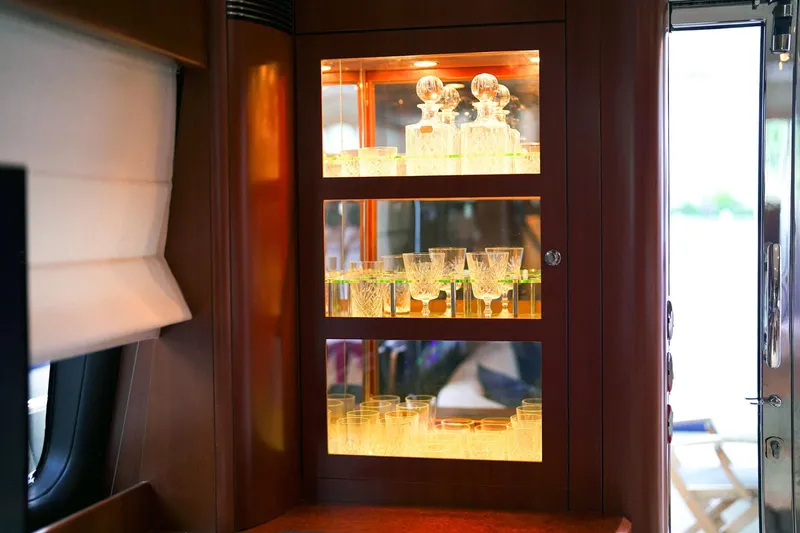 Kristina Yacht Photos Pics Luxurious glassware display in a 2007 Princess 23M yacht interior.
