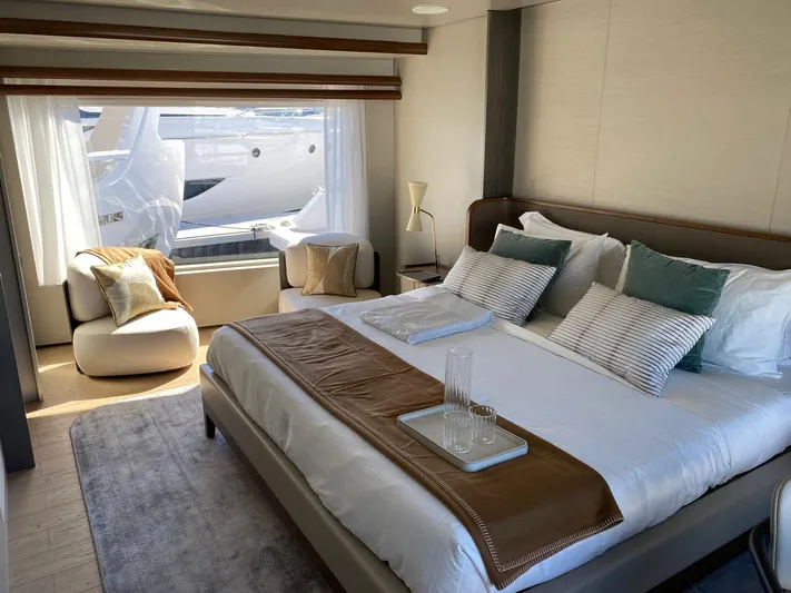  Yacht Photos Pics Luxurious bedroom interior of 2024 Azimut Magellano 30M yacht with elegant decor and large window.