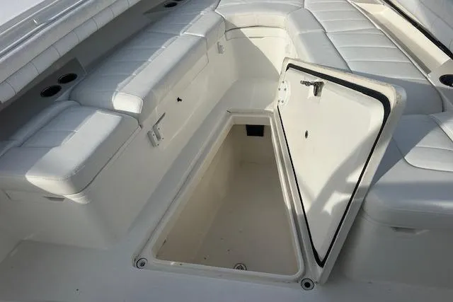 Resolute Yacht Photos Pics 2017 Regulator 31 boat with open storage compartment and cushioned seating.