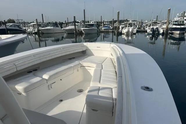 Resolute Yacht Photos Pics 2017 Regulator 31 boat with white seating, docked in a marina.