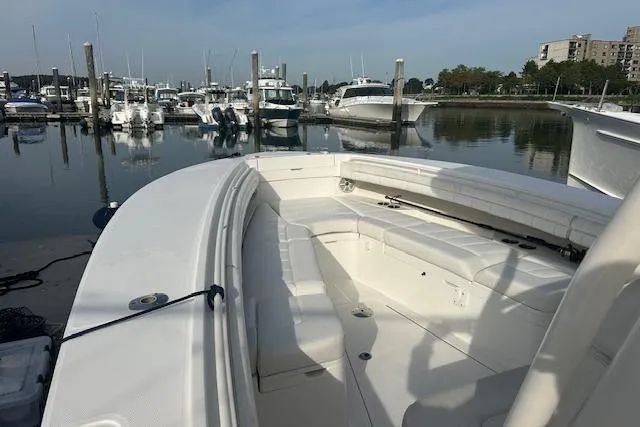 Resolute Yacht Photos Pics 2017 Regulator 31 boat docked at marina with calm water and other boats.