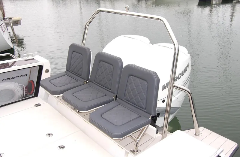  Yacht Photos Pics Three gray seats on a 2019 Axopar 37 SC boat, near water.
