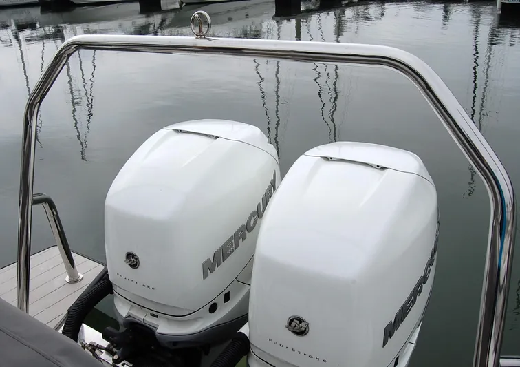  Yacht Photos Pics Twin Mercury outboard engines on a 2019 Axopar 37 SC boat at a marina.