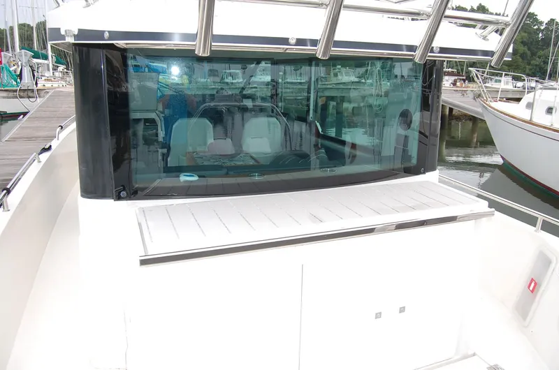  Yacht Photos Pics 2019 Axopar 37 SC boat with sleek design, docked at a marina.