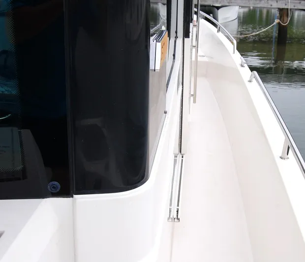  Yacht Photos Pics Side view of a 2019 Axopar 37 SC boat docked by the water.