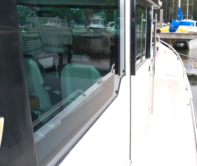  Yacht Photos Pics 2019 Axopar 37 SC boat docked, showcasing sleek design and windows.