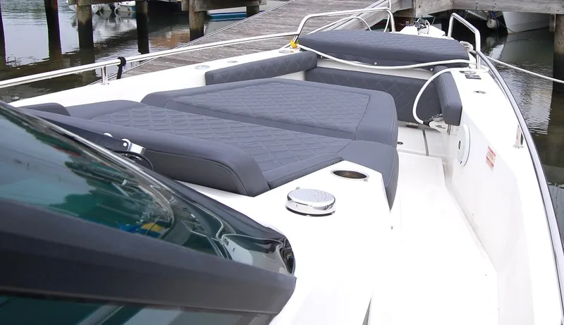  Yacht Photos Pics 2019 Axopar 37 SC boat with cushioned deck, docked at marina.
