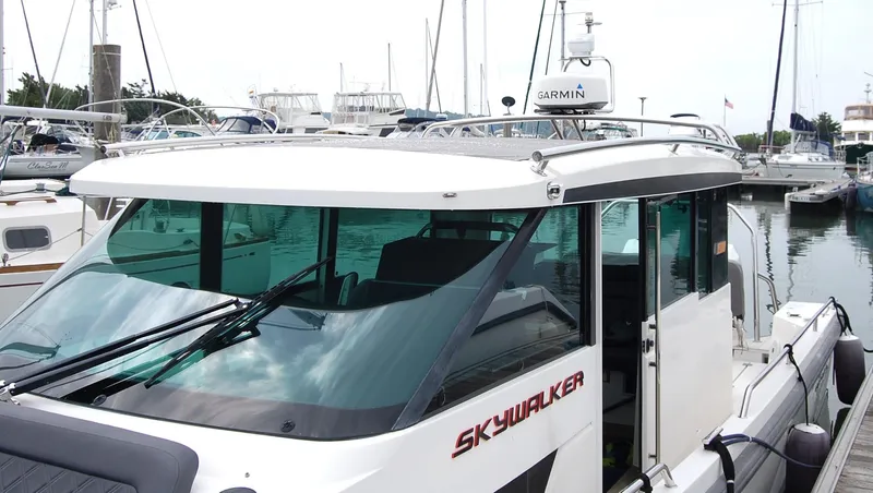  Yacht Photos Pics 2019 Axopar 37 SC boat docked in a marina, featuring sleek design and Garmin equipment.