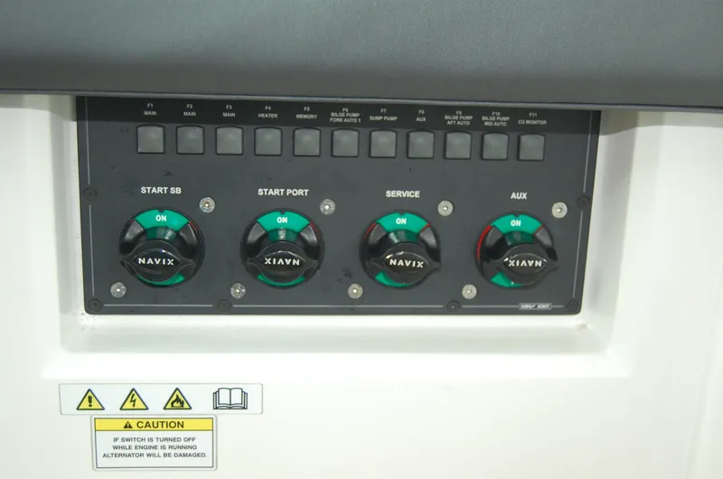  Yacht Photos Pics Control panel of 2019 Axopar 37 SC boat with labeled switches and caution sign.