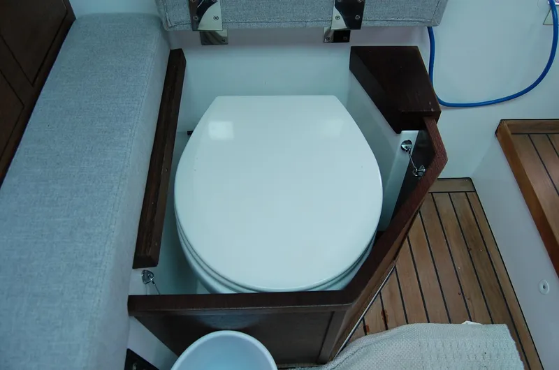  Yacht Photos Pics Toilet on 2019 Axopar 37 SC boat, featuring wooden accents and compact design.