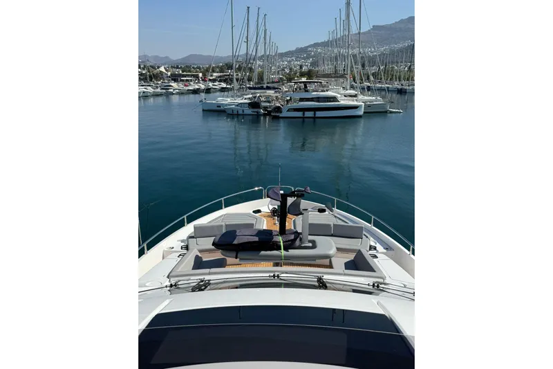 Svetlana Yacht Photos Pics 2025 Sunseeker 76 Yacht docked in a serene marina with scenic mountain backdrop.