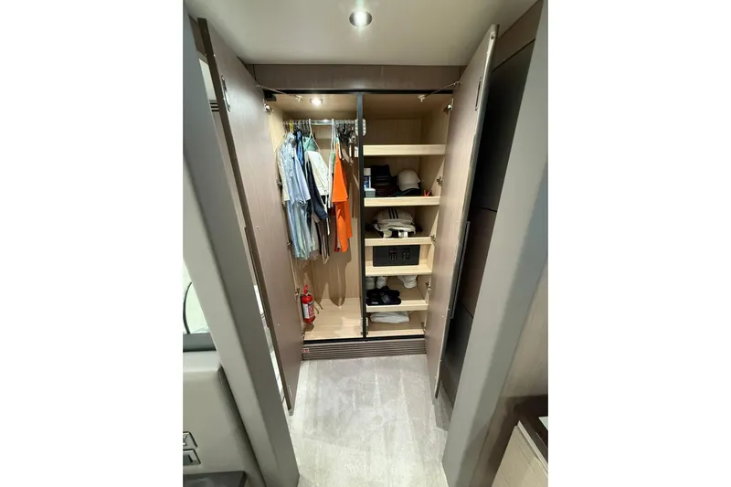 Svetlana Yacht Photos Pics Luxurious Sunseeker 76 Yacht 2025 wardrobe with clothes, shelves, and safe.