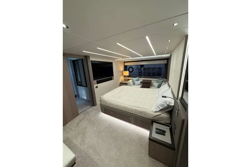 Svetlana Yacht Photos Pics Luxurious bedroom interior of 2025 Sunseeker 76 Yacht with modern design and ambient lighting.