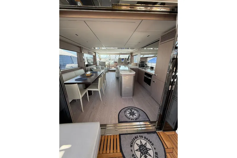 Svetlana Yacht Photos Pics Luxurious interior of 2025 Sunseeker 76 Yacht with modern dining and kitchen area.